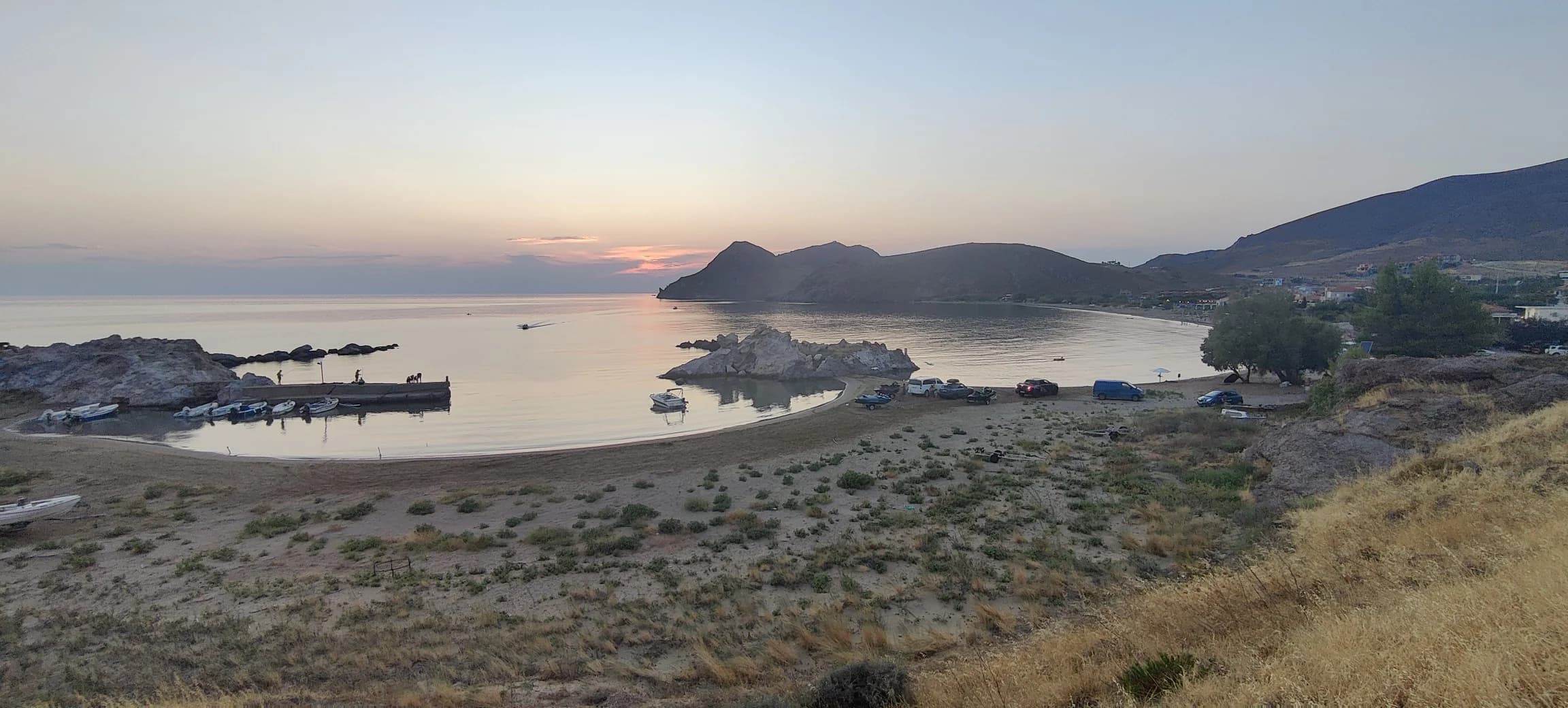 Coastal bay at sunset with boats, from John Andrew Hazlewood's 5 Years Later Facebook photo